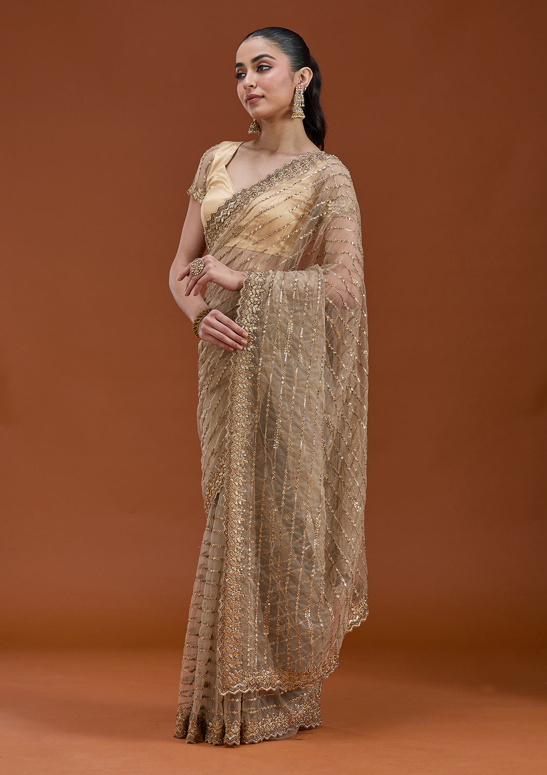 Beige Net Sequins Saree With Matching Blouse Piece