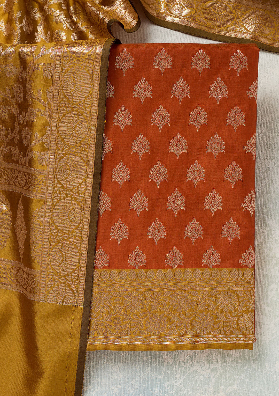 Rust Mustard Yellow Silk Bandhej Gold Zariwork Unstitched Dress Material With Matching Bottom And Dupatta